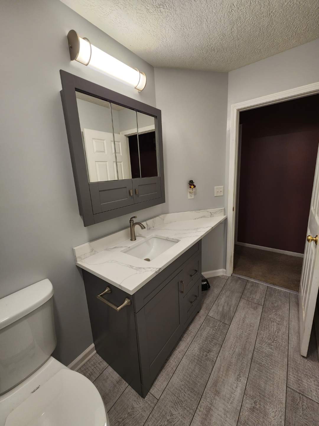 Modern Bathroom with Dark Vanity and Marble Countertop